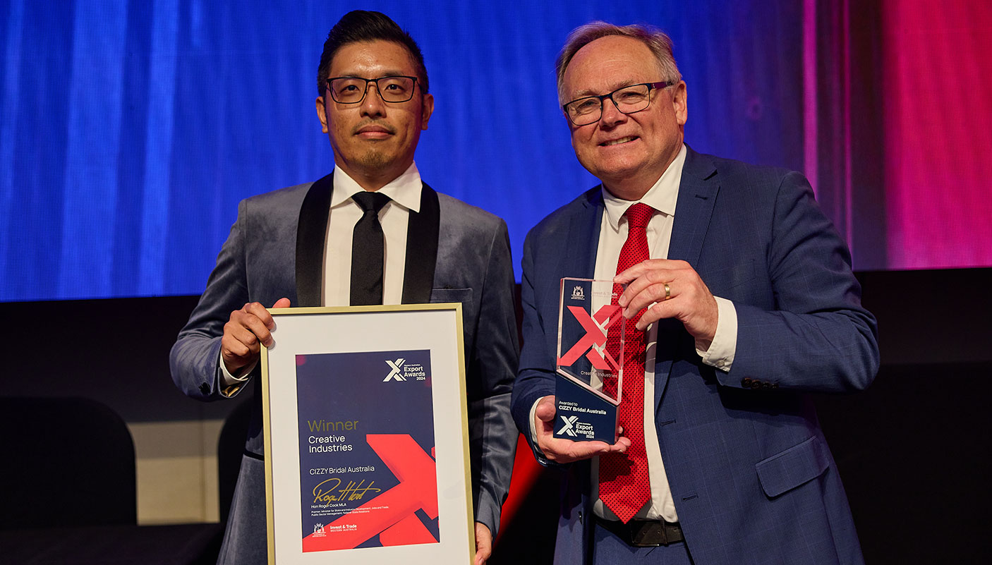 Two men stand with a certificate and trophy at the WA Export Awards 2024.