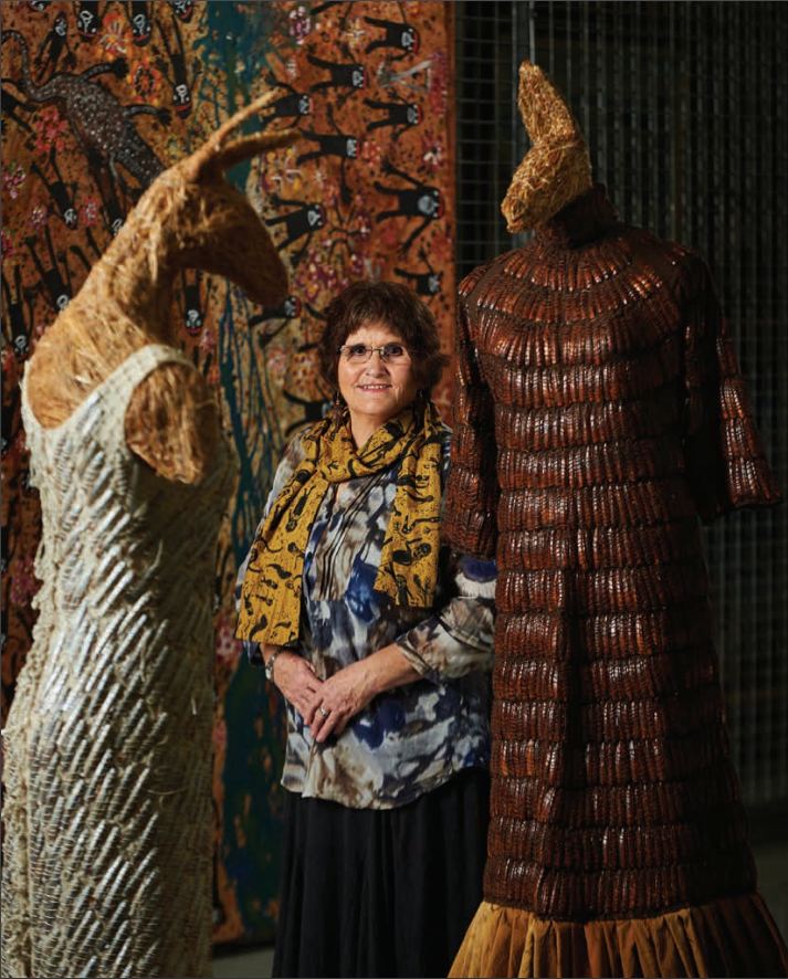 Nalda Searles standing next to two of her creations