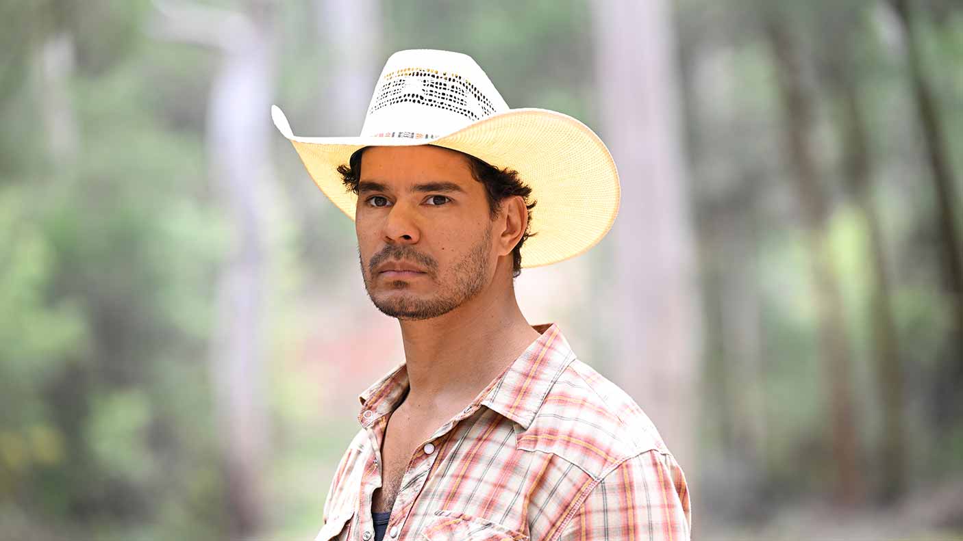 Mark Coles Smith as Detective Jay Swan in Mystery Road Origin 2, stands in a South West forest