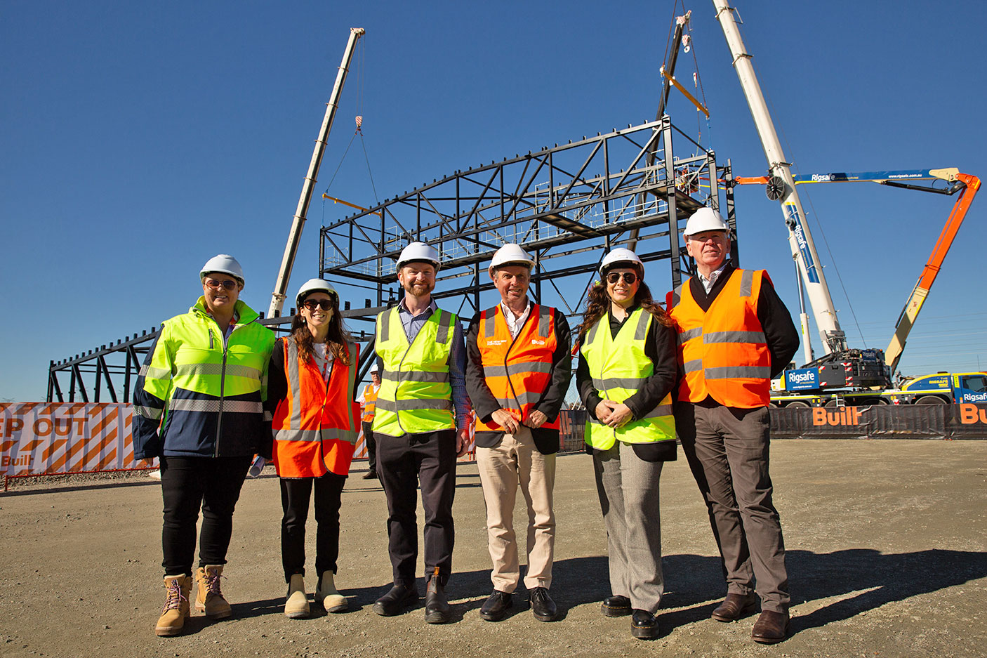 A group of staff members standing in front of the construction site of the Perth Film Studios