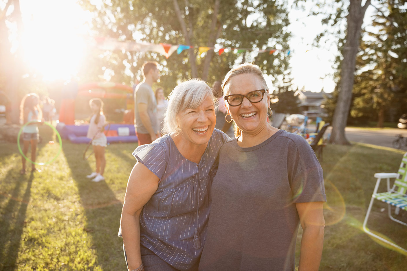 Two women smiling in a park