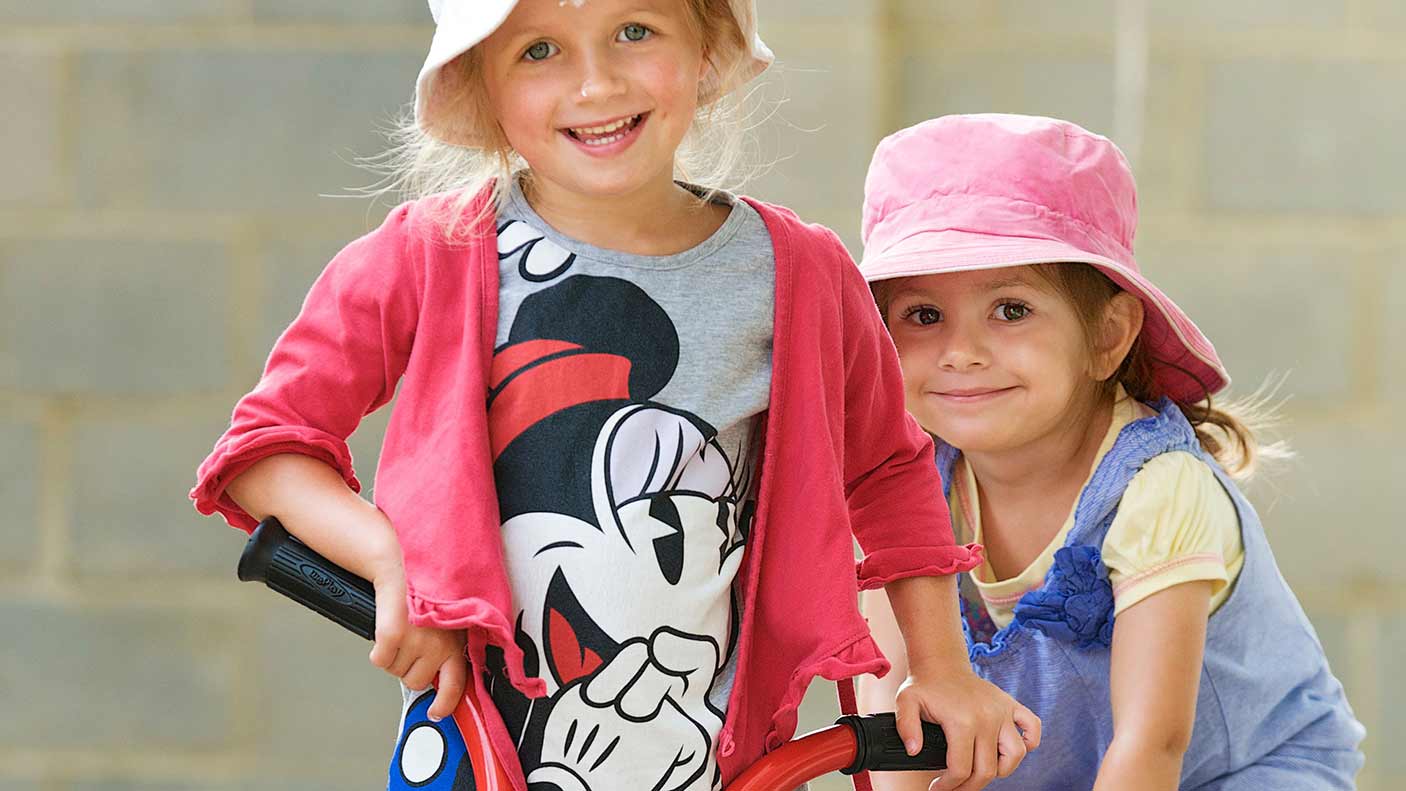 Two girls on bikes at day care