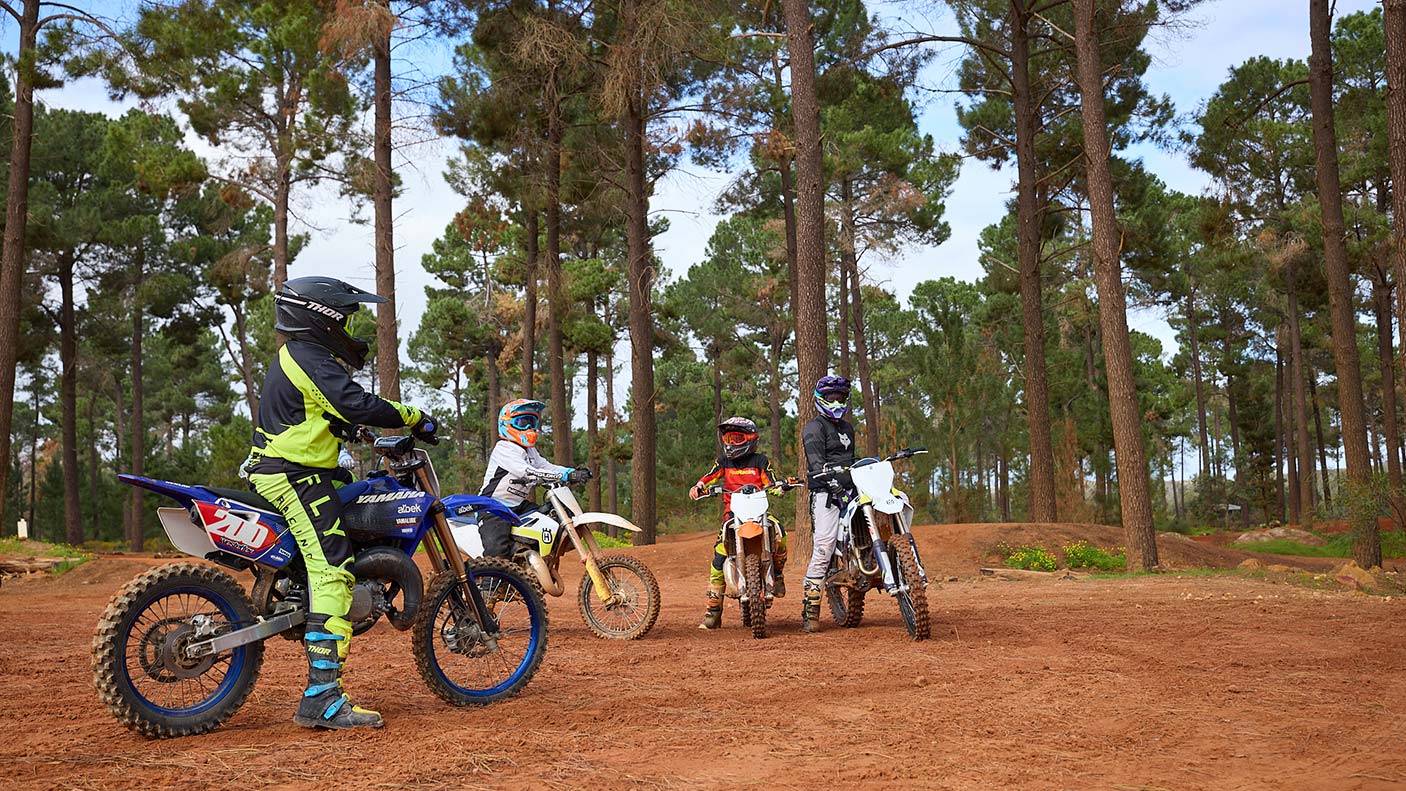 4 off-road motorcyclists on a dirt track