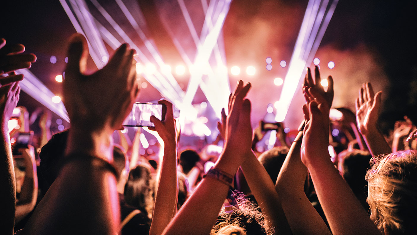 A section of a crowded nightclub, with lots of people and lights