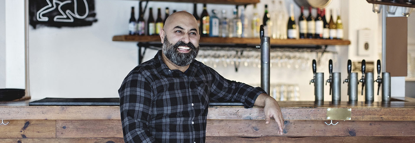 Liquor licensee leaning on a bar Stock image of a publican leaning on a bar