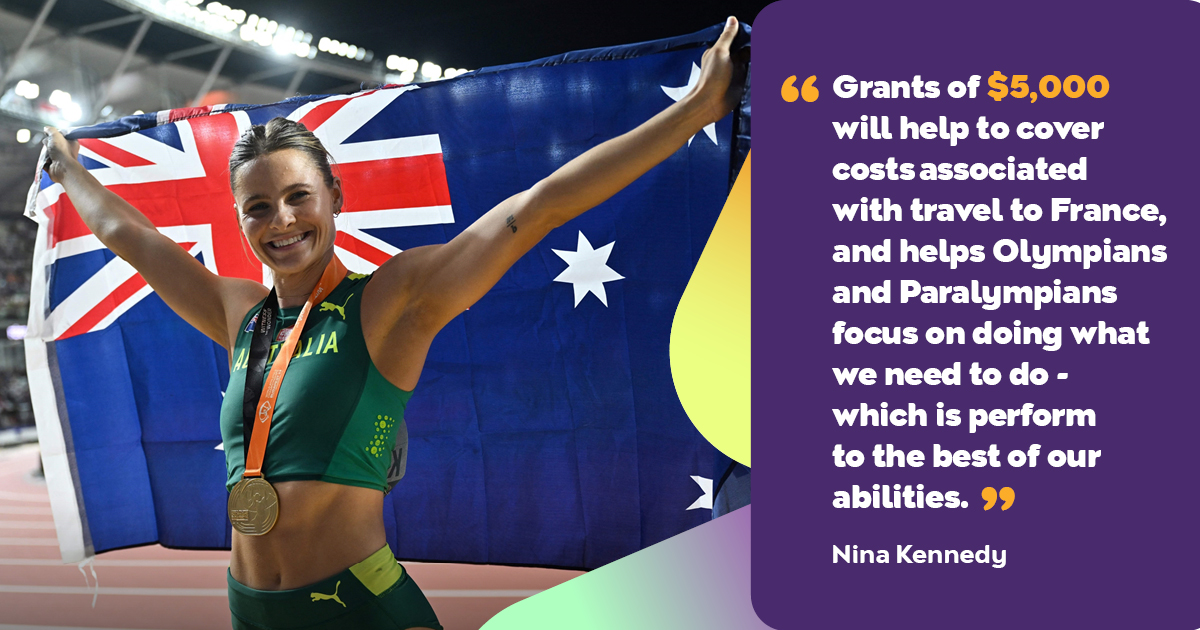 Athlete Nina Kennedy holds up the Australian flag.