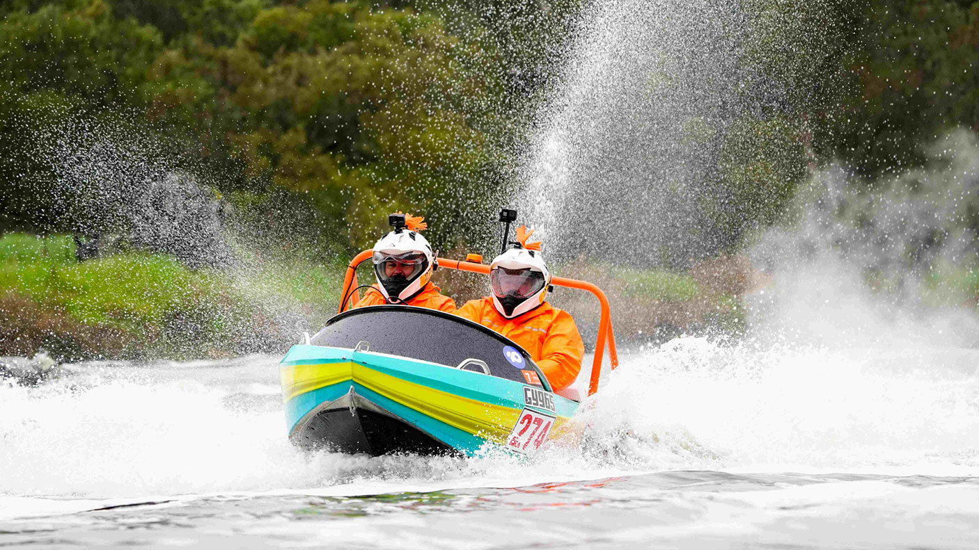 Two people in a powerboat at the 2023 Avon Descent