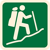 Symbol for Australian Walking Track Grade 5: figure with a backpack and walking pole hikes a steep incline,