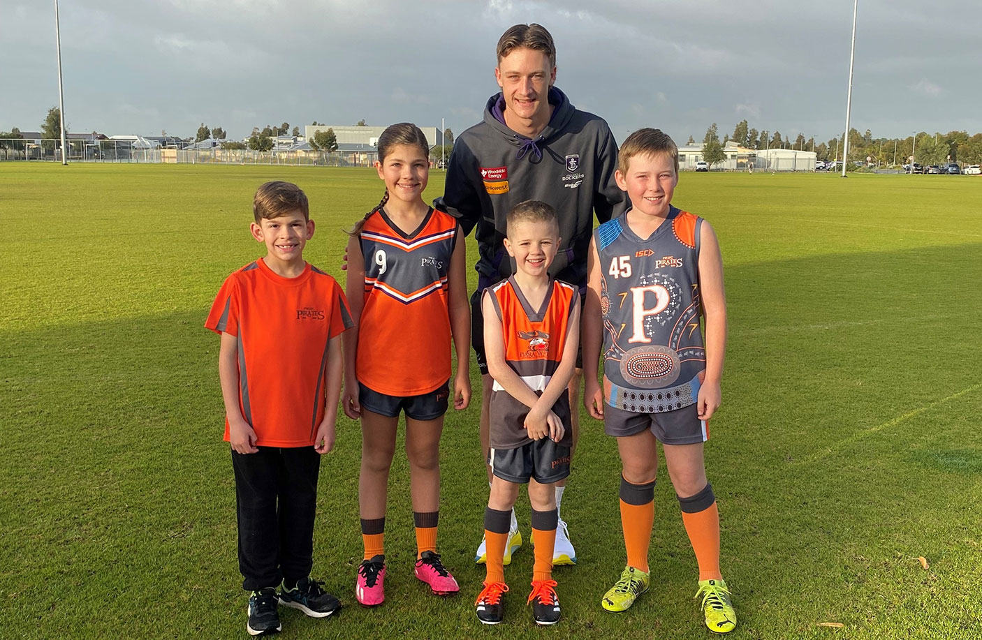 Fremantle Dockers forward Jye Amiss at KidSport Club, Piara Waters Junior Football Club with players William, Siena, Hunter and Aidan.