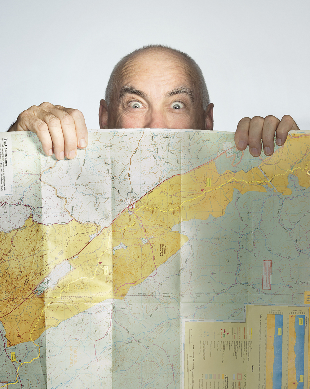 Portrait of Mike Wood behind a map