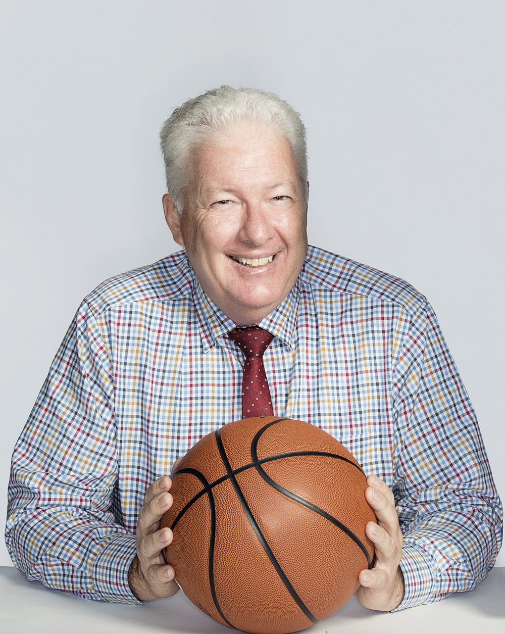 Portrait of Neil Kegie with a basketball